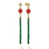 These diamond lotus earrings feature two coral gemstones with vibrant green garnet drops.