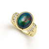 An oval shaped black opal gemstone and round diamonds are set in smooth 18k gold to form this statement ring. LAGOS diamonds are the highest quality natural stones.