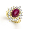 This exquisite ring centers around a radiant, oval-cut pink rubellite. This gemstone is encased in a lustrous gold setting. Radiating outward are the sparkling diamonds, meticulously arranged in a sunburst pattern that enhances the ring's allure.