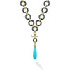 This sleek turquoise pendant is suspended by onyx circles adorned with 18K Caviar Gold links. Diamond accents give this piece a touch of brilliance.