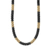 Twelve medium 18K gold stations highlighted by black ceramic Caviar beading on this necklace finished with an 18K gold lobster clasp.