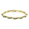 18k gold and blue sapphire gemstones form this luxe link wave bracelet.