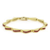 18K gold and ruby gemstones form this luxe link wave bracelet.