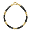 Five large gold bead stations highlighted by black ceramic Caviar beading form this signature bracelet